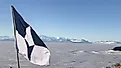 The flag of Antarctic flies above the Ross Ice Shelf near McMurdo Station, Antarctica